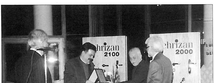 Close-up of award presentation at the 1st Grand Memar Award, recipient receiving plaque